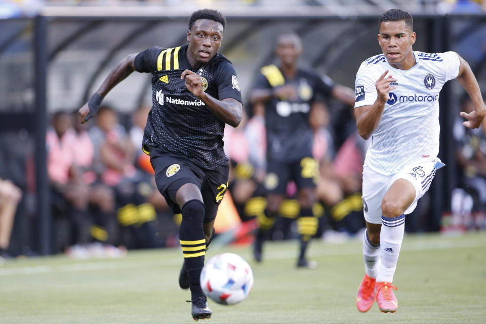 Columbus Crew's Derrick Etienne left, and Chicago Fire's Miguel Angel Navarro chase the ball during the first half of an MLS soccer match Saturday, June 19, 2021, in Columbus, Ohio. (AP Photo/Jay LaPrete)