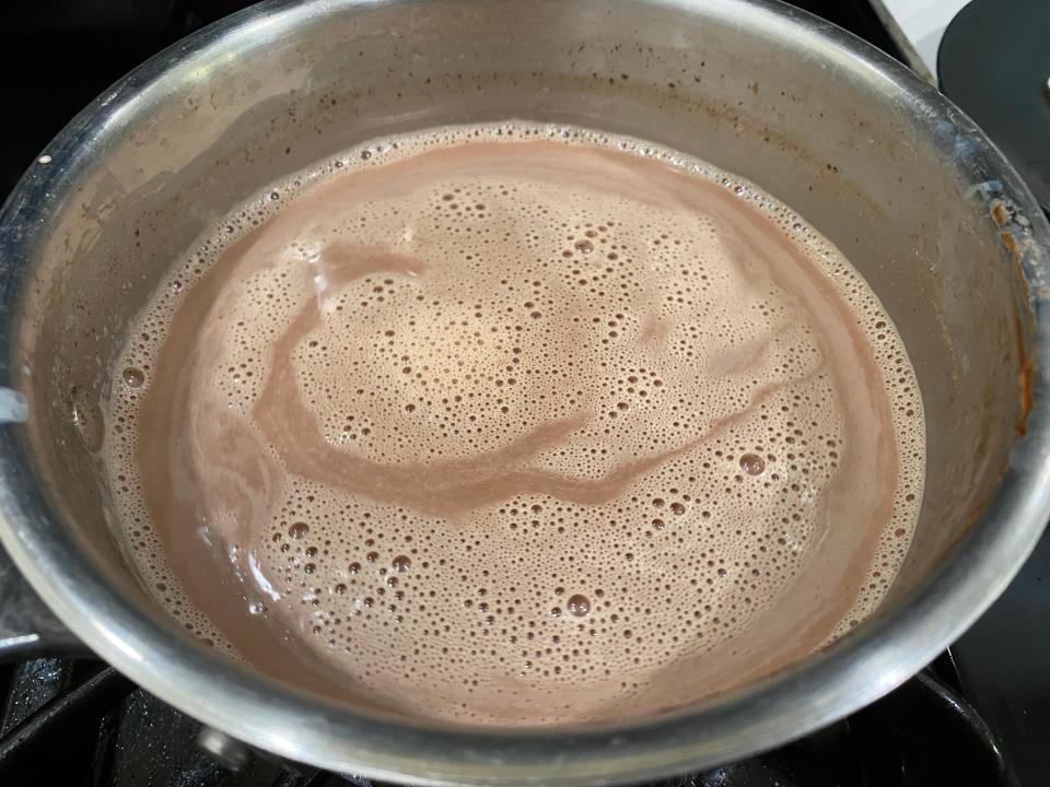 heating chocolate and milk for Ina Garten hot chocolate in pan
