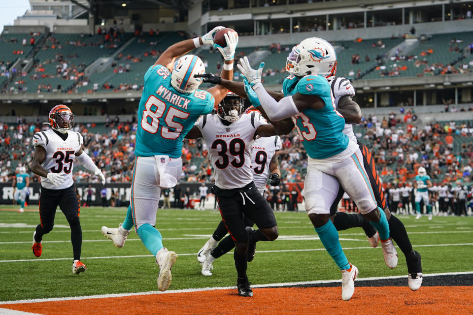 Miami Dolphins tight end Chris Myarick (85) makes a catch for a touchdown over Cincinnati Bengals defensive back Winston Rose (39) in the second half of an NFL exhibition football game in Cincinnati, Sunday, Aug. 29, 2021. (AP Photo/Bryan Woolston)