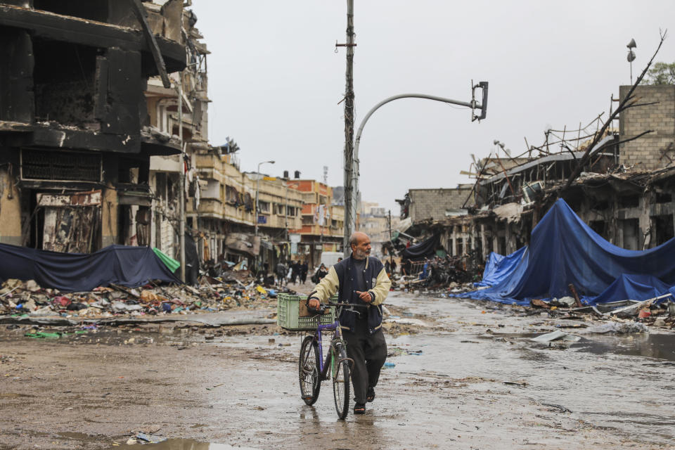 A Palestinian walks in Gaza City on Monday, Nov. 27, 2023. on the fourth day of the temporary ceasefire between Hamas and Israel. (AP Photo/Mohammed Hajjar)