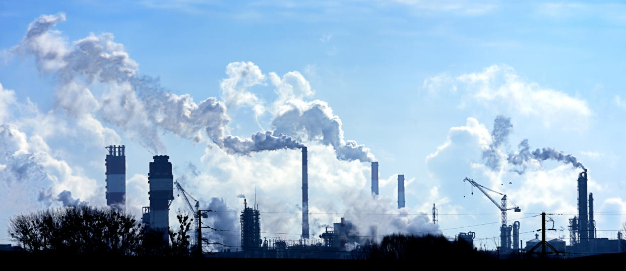 Air pollution from smoke coming out of factory chimneys.