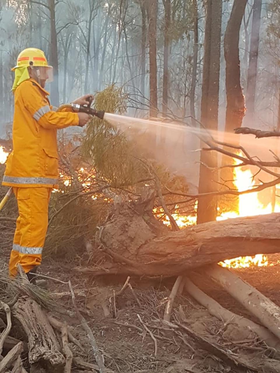 A Queensland firefighter fighting a blaze near Millmerran west of Toowoomba.