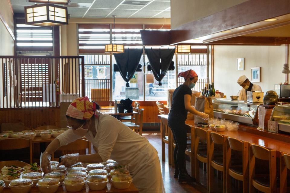 Ikuko Nagasu, Mirai Nagasu's mother, packs lunches for medical workers at their restaurant Sushi Kiyosuzu in Arcadia on Tuesday.