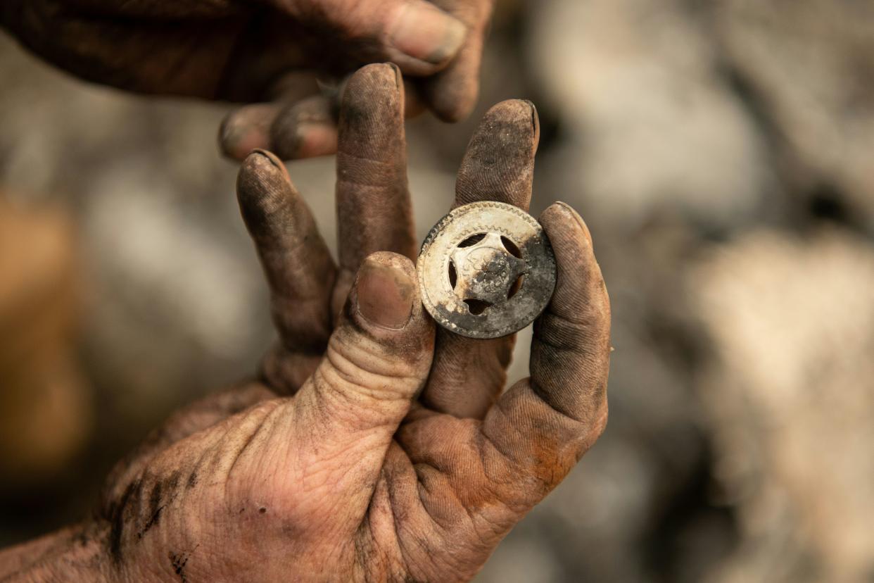 Ryan Spainhower displays a coin 