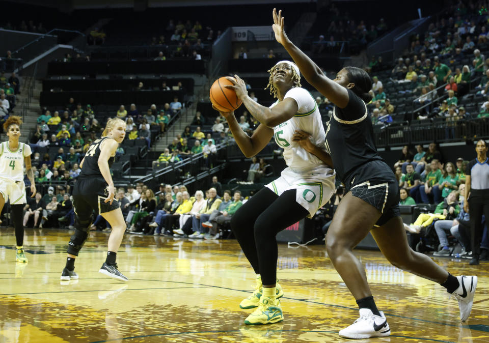 Oregon center Phillipina Kyei shoots against Colorado center Aaronette Vonleh during the first half of an NCAA college basketball game in Eugene, Ore., Sunday, Jan. 28, 2024. (AP Photo/Thomas Boyd)