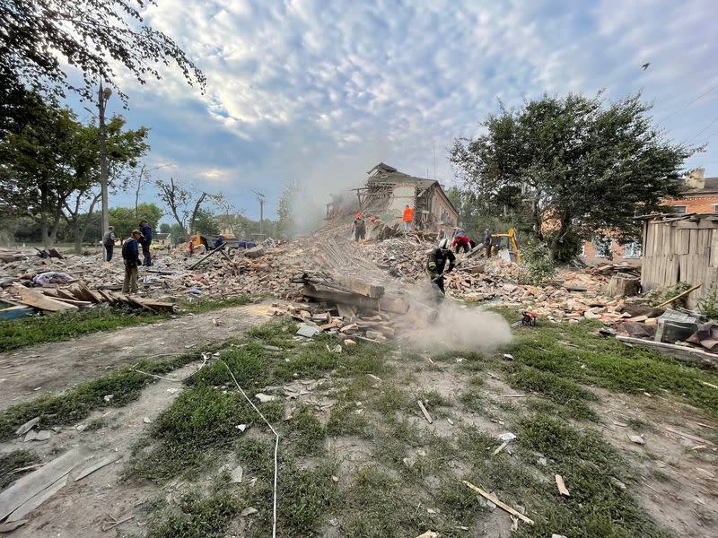 Handout image shows emergency crew working amidst collapsed building site in Chuhuiv Town, Kharkiv