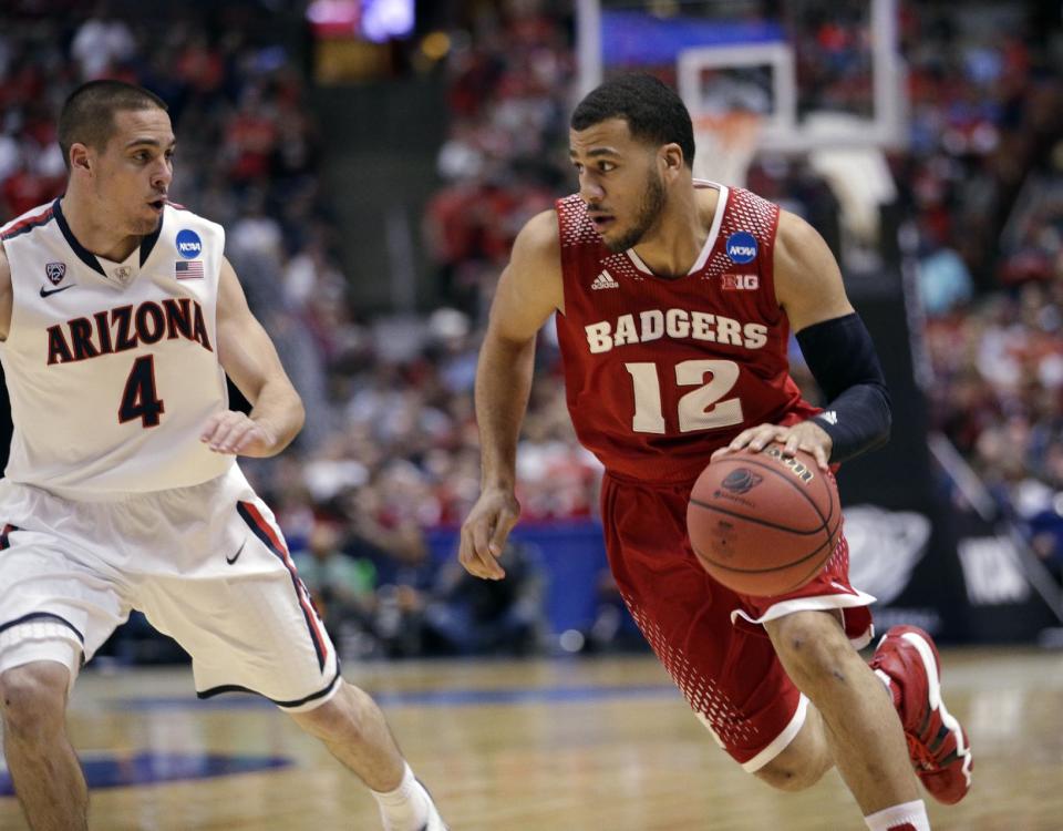 Wisconsin 's Traevon Jackson drives past Arizona's T.J. McConnell during the first half in a regional final NCAA college basketball tournament game, Saturday, March 29, 2014, in Anaheim, Calif. (AP Photo/Jae C. Hong)