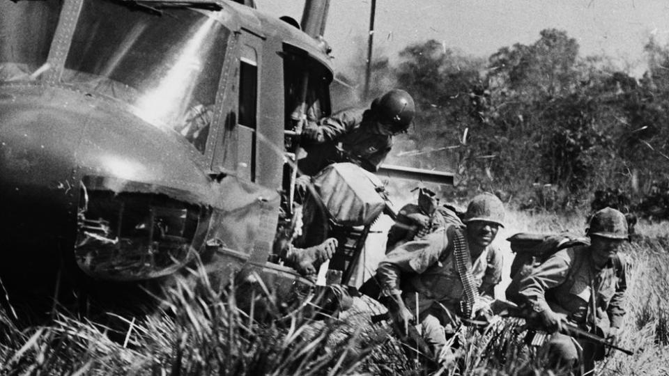 VIETNAM -- 1971: American soldiers jump out of a helicopter during a combat assault near M Tho in the Mekong Delta, South Vietnam