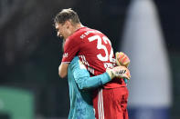 Bayern's goalkeeper Manuel Neuer, left, and Bayern's Joshua Kimmich celebrate end of the German Bundesliga soccer match between Werder Bremen and Bayern Munich in Bremen, Germany, Tuesday, June 16, 2020. Because of the coronavirus outbreak all soccer matches of the German Bundesliga take place without spectators. Bayern Munich secured its eighth successive German Bundesliga title Tuesday with two games to spare after beating Werder Bremen 1-0 with a goal from Robert Lewandowski. (AP Photo/Martin Meissner, Pool)