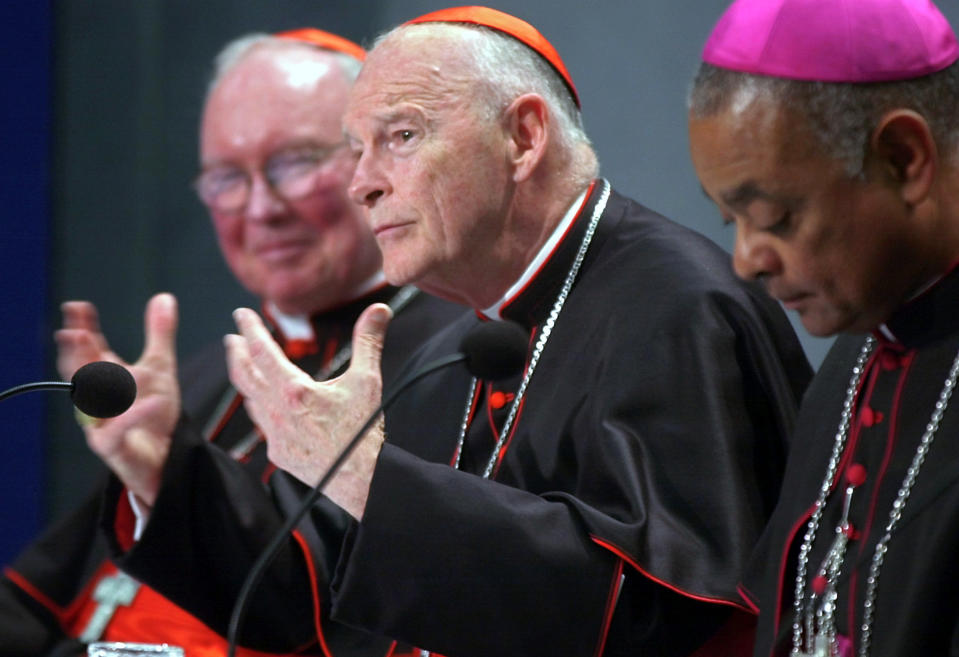 FILE - In this April 24, 2002 file photo, Cardinal James Francis Stafford, left, Pontifical Council for the Laity at the Vatican, Cardinal Theodore Edgar McCarrick of Washington, D.C., center, and United States Catholic Bishops' Conference President Wilton Gregory of Belleville, Ill., attend a news conference at the Vatican concluding a two-day meeting between Pope John Paul II and US cardinals at the Vatican. After an extraordinary meeting sparked by a sex abuse scandal, American Roman Catholic leaders agreed to make it easier to remove priests guilty of sexually abusing minors - but they stopped short of a zero-tolerance policy to dismiss all abusive priests. (AP Photo/Pier Paolo Cito, File)