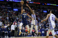 New Orleans Pelicans guard CJ McCollum (3) shoots against Sacramento Kings guard Davion Mitchell (15) in the first half of an NBA basketball game in New Orleans, Sunday, Feb. 5, 2023. (AP Photo/Matthew Hinton)