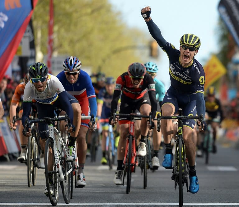 Orica's South African cyclist Daryl Impey (R) celebrates his victory as he crosses the finish line followed by Movistar's Spanish rider Alejandro Valverde (L) on the sixth day of the 97th Volta Catalunya 2017 in Reus on March 25, 2017