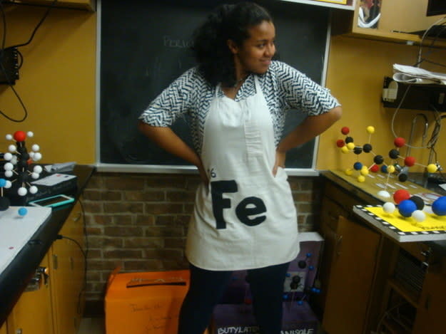 person wearing an apron that reads "Fe"