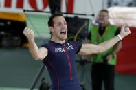 Renaud Lavillenie of France celebrates after clearing the bar at 5.90 meters during the men's pole vault event at the IAAF World Indoor Athletics Championships in Portland, Oregon March 17, 2016. REUTERS/Lucy Nicholson