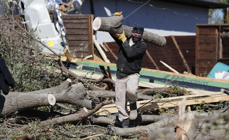 Ian Hardy removes trees fallen by a tornado in Dallas, Tuesday, Oct. 22, 2019. The National Weather Service says nine tornadoes struck the Dallas area during Sunday's stretch of severe storms in Texas. (AP Photo/LM Otero)