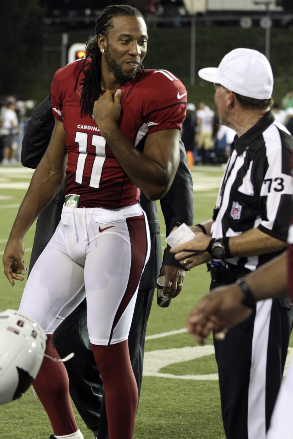 Arizona Cardinals wide receiver Larry Fitzgerald (11) talks with referee Craig Ochoa (73) during the third quarter of the Hall of Fame exhibition football game against the New Orleans Saints, Sunday, Aug. 5, 2012 in Canton, Ohio. The Saints won 17-10.(AP Photo/Scott Galvin)