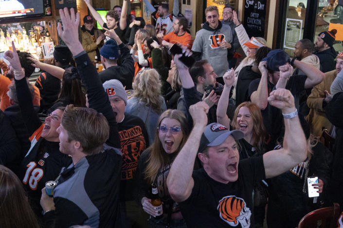 FILE - Cincinnati Bengals fans attend a watch party for NFL football's Super Bowl 56 against the Los Angeles Rams, Sunday, Feb. 13, 2022, at Mount Lookout Tavern in Cincinnati. The official global death toll from COVID-19 is on the verge of eclipsing 6 million — underscoring that the pandemic, now in its third year, is far from over. (AP Photo/Jeff Dean, File)