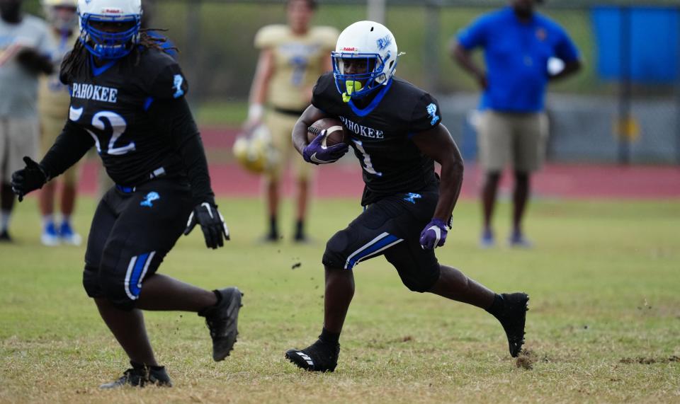 Pahokee’s Jashon Benjamin (1) looks for running room against Cardinal Newman on Thursday, August 25, 2022 in Pahokee.