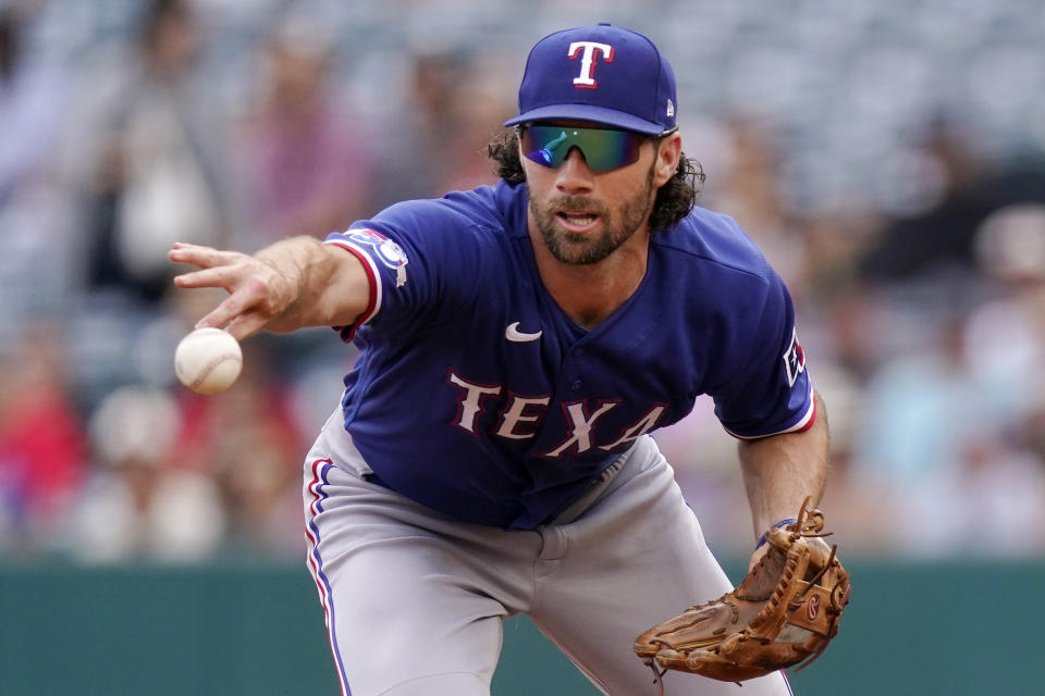 Texas Rangers second baseman Charlie Culberson tosses the ball to second to force out Los Angeles Angels' Luis Rengifo after fielding a ball hit by Jared Walsh during the first inning of a baseball game Sunday, July 31, 2022, in Anaheim, Calif. Walsh was thrown out at first for a double play. (AP Photo/Mark J. Terrill)