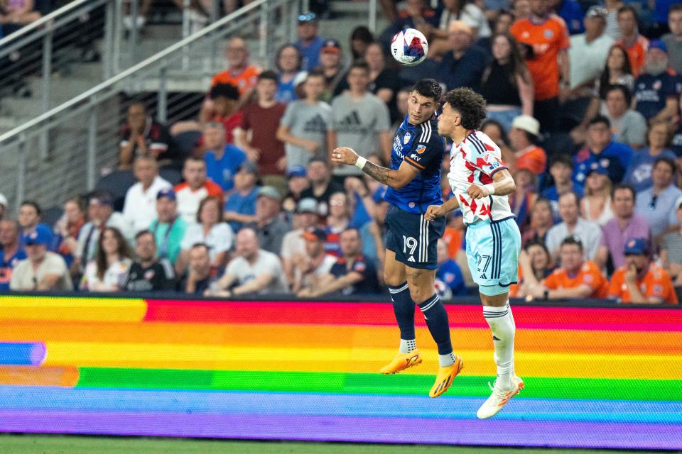 Chicago Fire defender Kendall Burks (27) heads the ball as FC Cincinnati forward Brandon Vázquez (19) leaps in the second half of the MLS match at TQL Stadium in Cincinnati on Saturday, June 3, 2023.