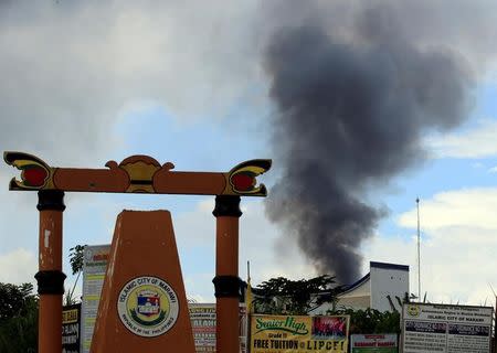 Black smoke coming from a burning building is seen as government troops continue their assault of insurgents from the so-called Maute group, who have taken over large parts of Marawi City, Philippines May 31, 2017. REUTERS/Romeo Ranoco