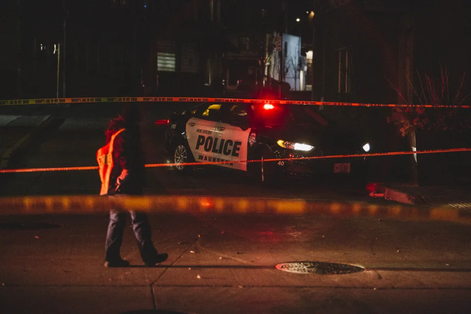 Police and emergency personnel work on a crime scene in November 21 in Waukesha, Wisconsin. 