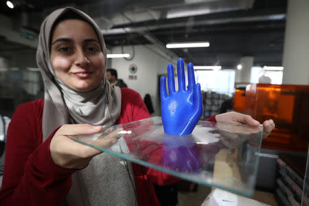 An employee shows a 3D-printed prosthetic hand, created at the FabLab in city of Irbid, Jordan February 26, 2019. Picture taken February 26, 2019. REUTERS/Muhammad Hamed