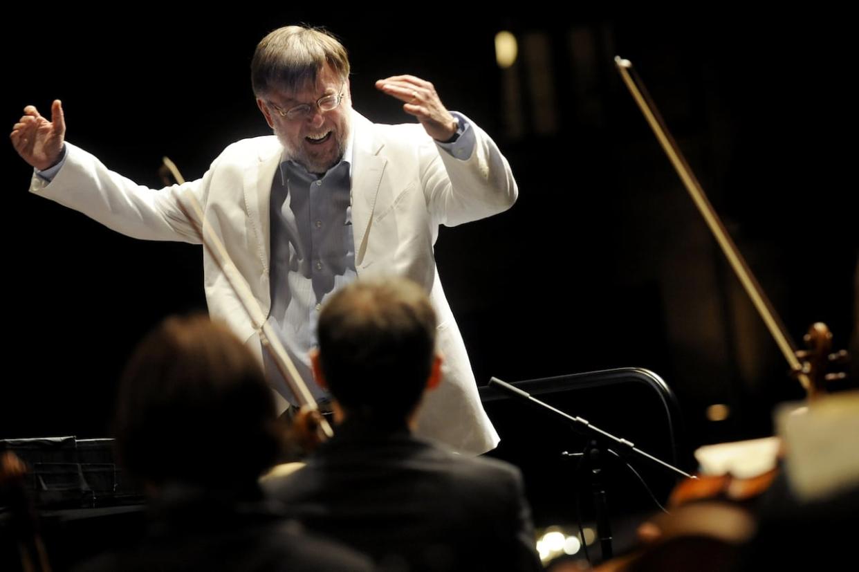 British conductor Sir Andrew Davis is shown in a performance on Sept. 17, 2010, in Besançon, eastern France. Davis died Saturday, aged 80. (Jeff Pachoud/AFP/Getty Images - image credit)