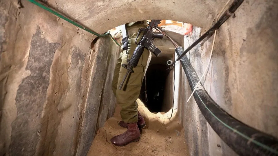 An Israeli soldier stands in an underground tunnel in Gaza City on November 22. - Victor R. Caivano/AP