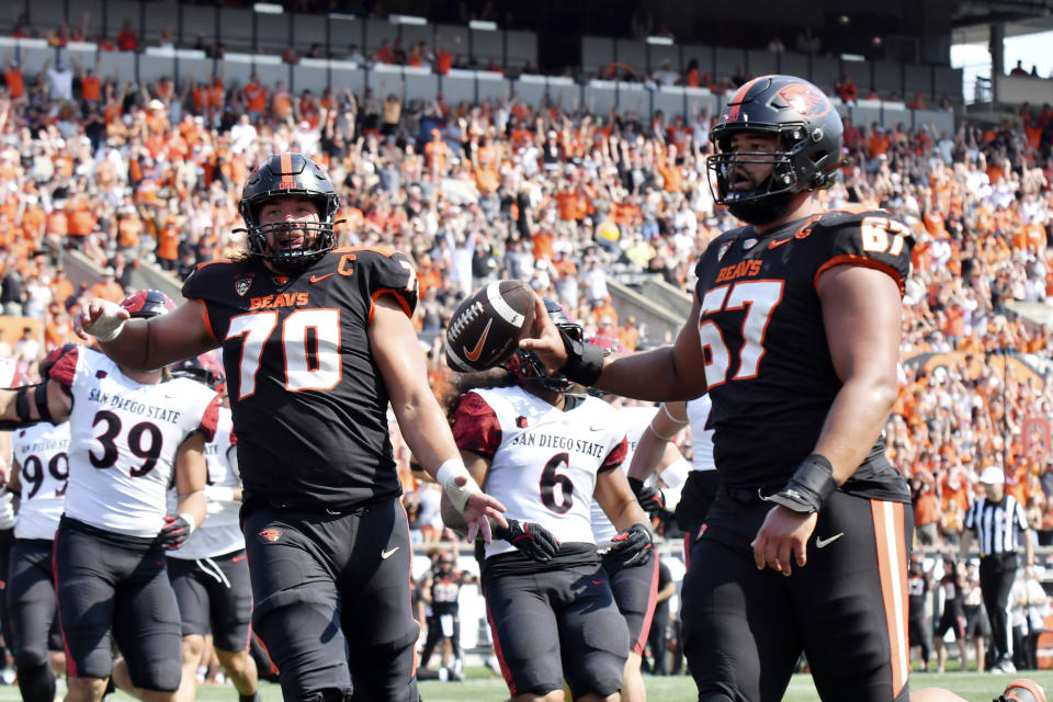 Oregon State offensive lineman Joshua Gray (67) celebrates his rushing touchdown with lineman Jake Levengood (70) during the first half of an NCAA college football game against San Diego State, Saturday, Sept. 16, 2023, in Corvallis, Ore. (AP Photo/Mark Ylen)