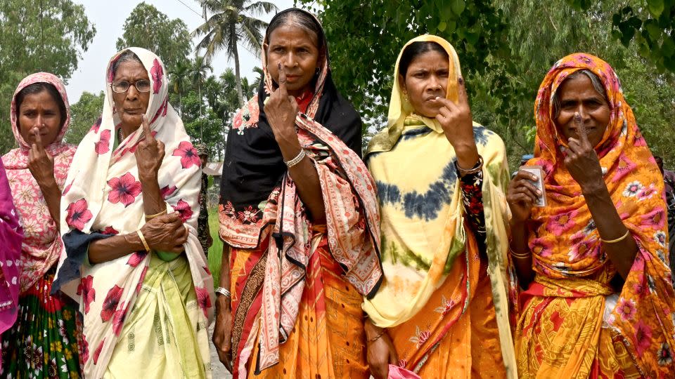 Women shows their inked fingers after casting their ballots to vote near the India-Bangladesh border in Seoraguri village, Dinhata district of Cooch Behar in the country's West Bengal state on April 19, 2024. - Dibyangshu Sarkar/AFP/Getty Images