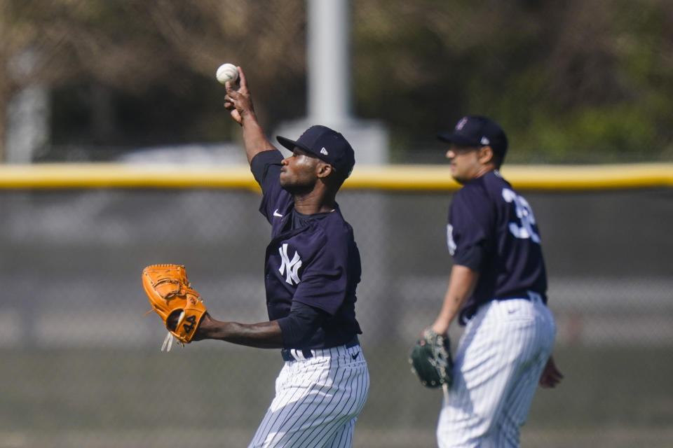 New York Yankees' Domingo German, left, warms up during a spring training baseball workout Monday, Feb. 22, 2021, in Tampa, Fla. (AP Photo/Frank Franklin II)