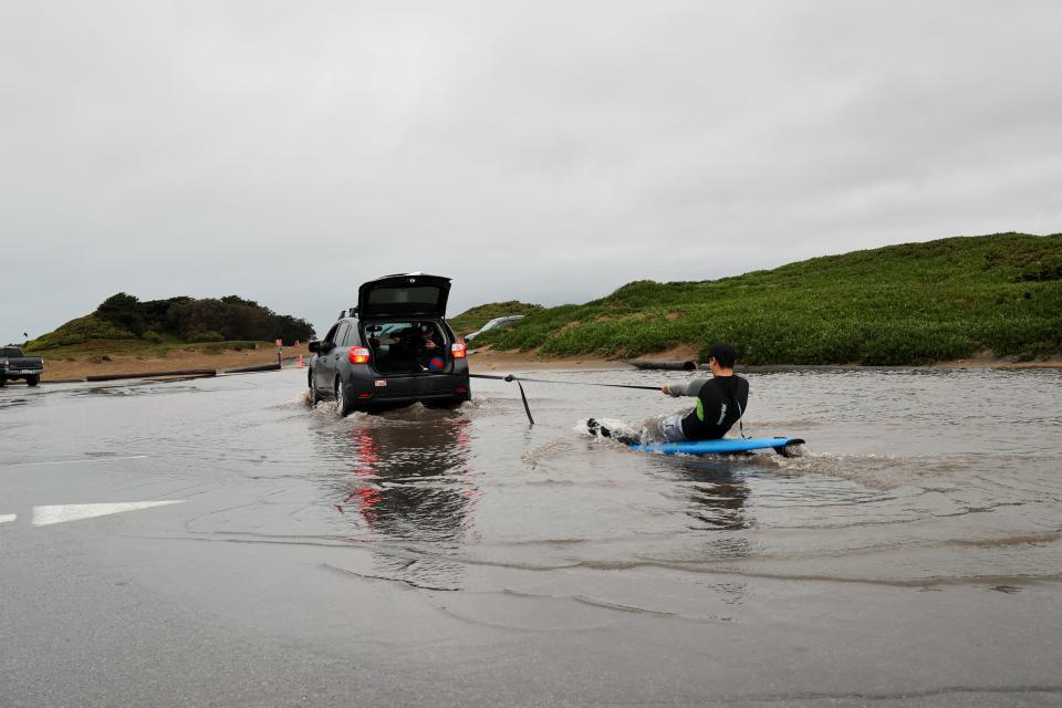 Jose Martin surfs in a flood at Fort Funston in San Francisco (Anadolu Agency via Getty Images)