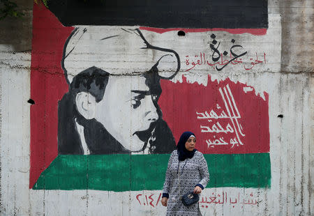 A woman walks past a mural painted in the colours of the Palestinian flag in Nazareth, an Arab city in northern Israel May 9, 2019. REUTERS/Ammar Awad