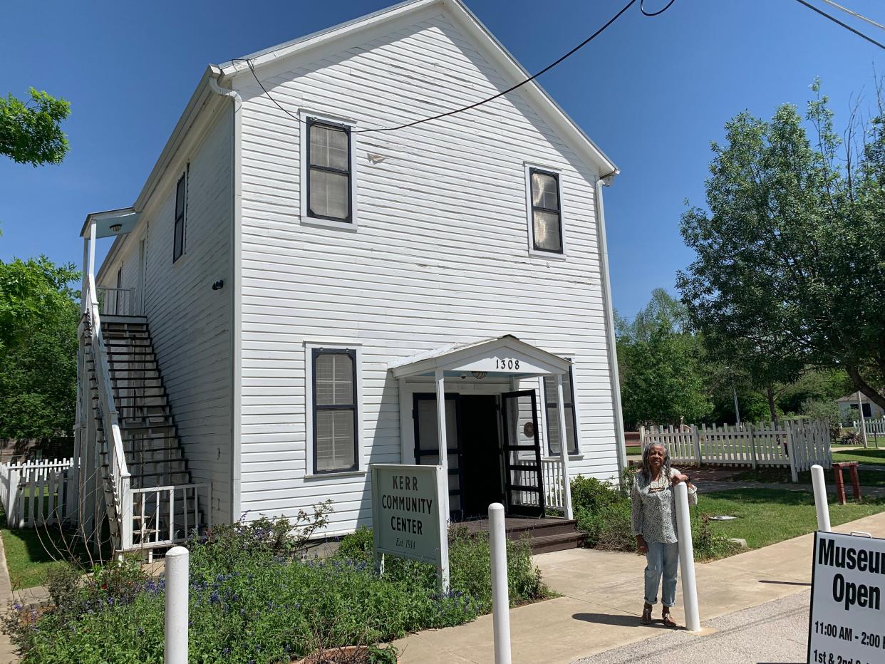 Retired Army Lt. Col. Doris Williams stands in front of Bastrop's Kerr Community Center, once known as the "Black USO" during World War II. It is now home to the Bastrop County African American Cultural Center and showcases an exhibit on the county's freedom colonies.