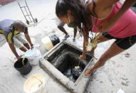 People extract water from an unknown source in the low-income neighbourhood of Petare amid the coronavirus disease (COVID-19) outbreak in Caracas