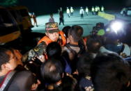 Family members of passengers of a sunken cruise ship push a cordon of paramilitary police as they march toward the site of the sunken ship in the Jianli section of Yangtze River, Hubei province, China, June 3, 2015. REUTERS/Kim Kyung-Hoon