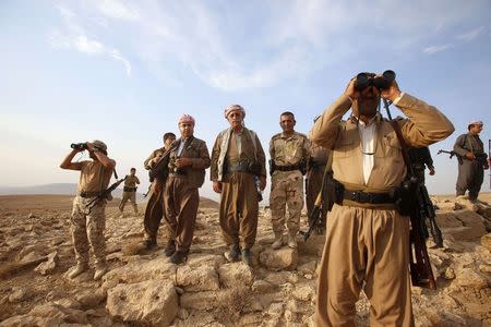 Kurdish Peshmerga forces stand guard near the town of Makhmur, south of Erbil, capital of Iraqi Kurdistan after Islamic State (IS) insurgents withdrew in this August 18, 2014 file photo. REUTERS/Youssef Boudlal/Files