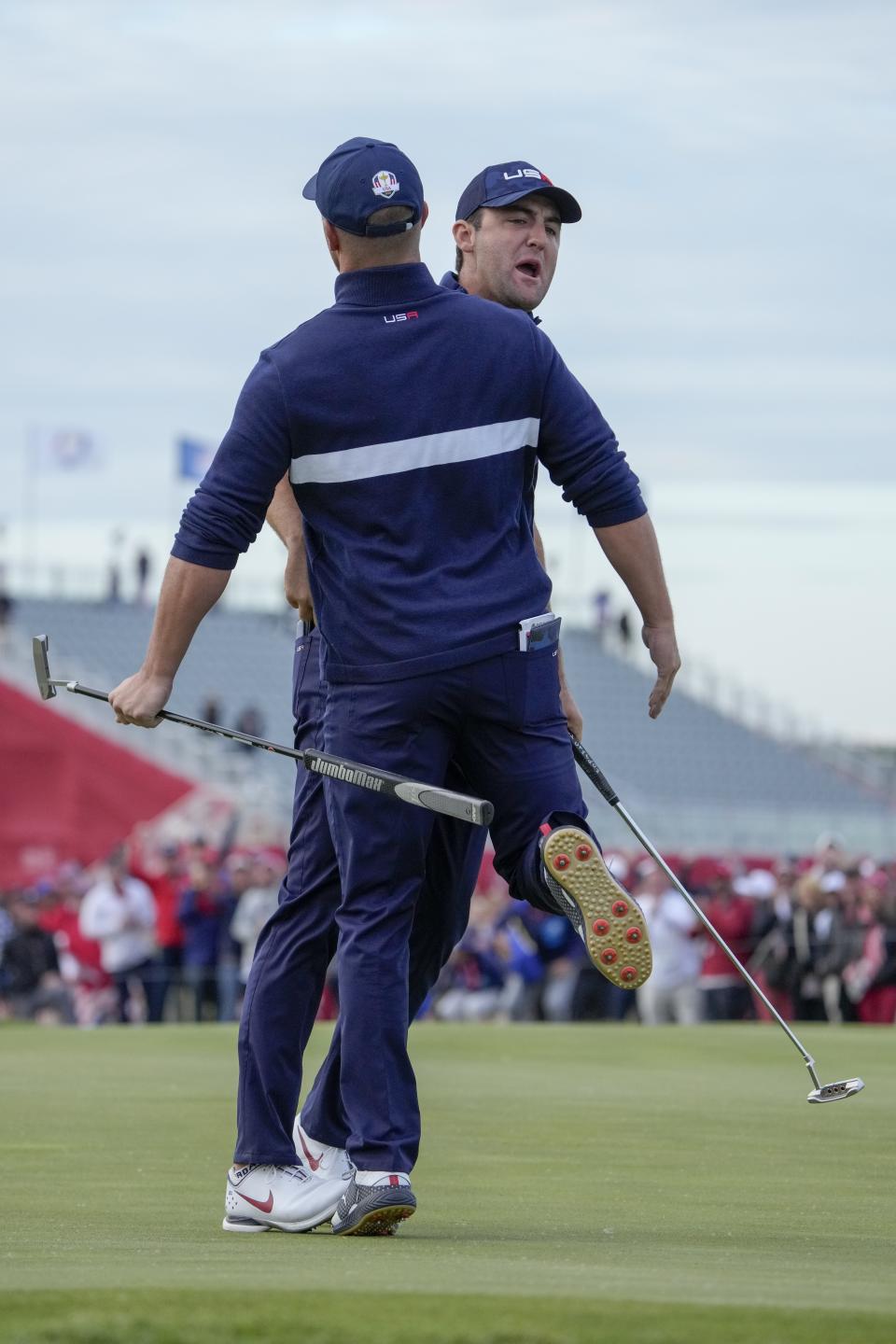 Team USA's Scottie Scheffler celebrates with Team USA's Bryson DeChambeau to making his putt and winning the 15th hole during a four-ball match the Ryder Cup at the Whistling Straits Golf Course Saturday, Sept. 25, 2021, in Sheboygan, Wis. (AP Photo/Ashley Landis)