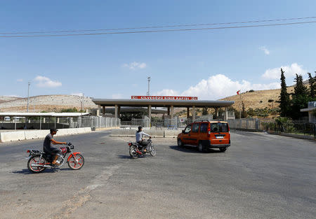 Syrians ride their motorcycles at the Turkish Cilvegozu border gate, located opposite the Syrian commercial crossing point Bab al-Hawa, in Reyhanli, Hatay province, Turkey, September 14, 2016. REUTERS/Osman Orsal