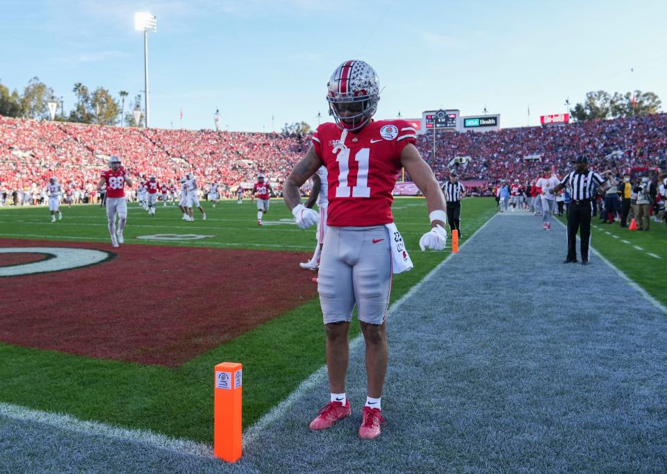 Sat., Jan. 1, 2022; Pasadena, California, USA; Ohio State Buckeyes wide receiver Jaxon Smith-Njigba (11) flexes after scoring a touchdown during the second quarter of the 108th Rose Bowl Game between the Ohio State Buckeyes and the Utah Utes at the Rose Bowl. 