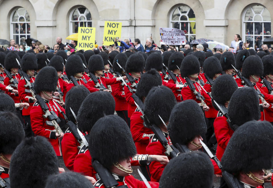 FILE- Grenadier Guards march past protesters demonstrate during the coronation ceremony of King Charles III at Westminster Abbey, London, Saturday May 6, 2023.Britain is one of the world's oldest democracies, but some worry that essential rights and freedoms are under threat. They point to restrictions on protest imposed by the Conservative government that have seen environmental activists jailed peaceful but disruptive actions. (Violeta Santos Moura/Pool Photo via AP, File)