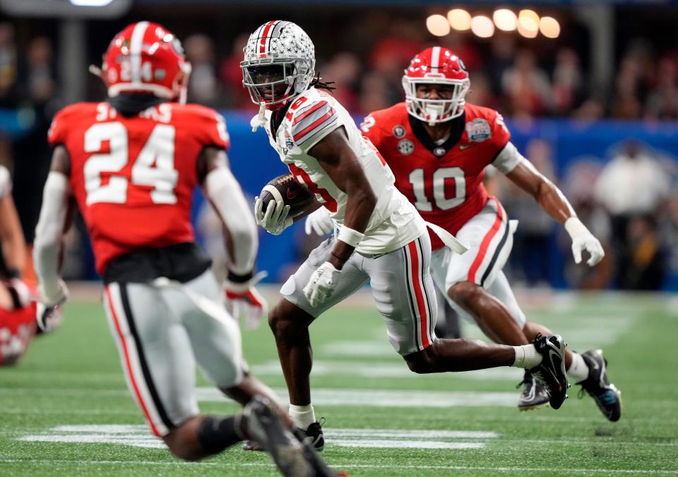 Ohio State wide receiver Marvin Harrison Jr. (18) runs after a catch against Georgia during the second quarter of the Peach Bowl in the College Football Playoff semifinal at Mercedes-Benz Stadium.