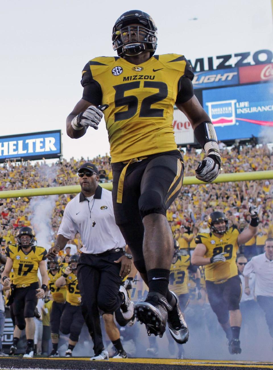 FILE - In this Sept. 8, 2012 file photo, Missouri's Michael Sam (52) runs onto the field along with their teammates before the start of an NCAA college football game against Georgia in Columbia, Mo. Sam was selected in the seventh round, 249th overall, by the St. Louis Rams in the NFL draft Saturday, May 10, 2014. The Southeastern Conference defensive player of the year last season for Missouri came out as gay in media interviews this year. (AP Photo/Jeff Roberson, File)