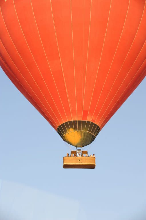 A hot air balloon flying over the ancient temple city of Luxor on July 29, 2008. A hot air balloon exploded and plunged to earth at Egypt's ancient temple city of Luxor during a sunrise flight on Tuesday, killing up to 19 tourists, including Asians and Europeans, sources said