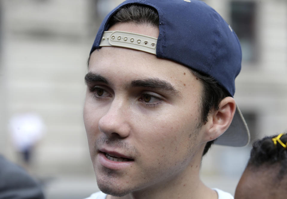 FILE - In this Aug. 23, 2018, file photo, David Hogg, a survivor of the school shooting at Marjory Stoneman Douglas High School, in Parkland, Fla., speaks with reporters before a march in Worcester, Mass. Hogg's remarks during a CNN interview is among those on a Yale Law School librarian's list of the most notable quotes of 2018: "We're children. You guys, like, are the adults. You need to take some action and play a role. Work together, come over your politics and get something done." (AP Photo/Steven Senne, File)