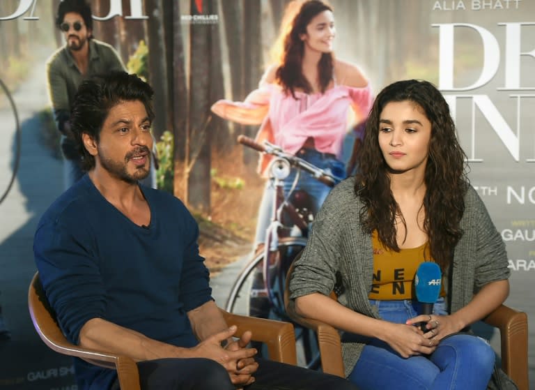 Actress Alia Bhatt with Bollywood's Shah Rukh Khan (L), who says he doesn't see himself as a real-life mentor to young actors, but will give advice if asked