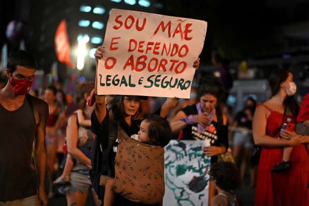 PHOTO: A woman holds a sign that says 'Sou Mae e Defendo o Aborto Legal e Seguro' (' I am a mother and I suport legal and safe abortions') during a demonstration to commemorate the International Womens Day in Rio de Janeiro, March 8, 2022.   (Mauro Pimentel/AFP via Getty Images, FILE)