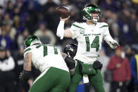 New York Jets quarterback Sam Darnold (14) throws a pass as Baltimore Ravens defensive end Jihad Ward, center, grabs at him during the first half of an NFL football game, Thursday, Dec. 12, 2019, in Baltimore. (AP Photo/Gail Burton)