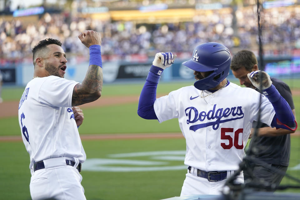 Los Angeles Dodgers' Mookie Betts (50) celebrates after his home run with David Peralta, left, during the first inning of a baseball game against the Houston Astros, Friday, June 23, 2023, in Los Angeles. (AP Photo/Jae C. Hong)